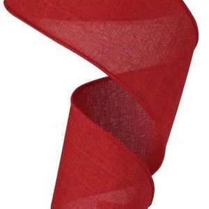 May include: A vibrant red ribbon, spiraling downwards against a white background. The ribbon has a textured, woven appearance, and its edges are neatly finished. This decorative ribbon is suitable for various crafting and gift-wrapping projects.