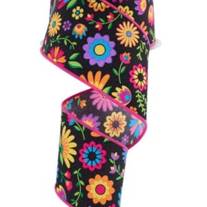 May include: A roll of 2.5 inch wide black ribbon with a colorful floral print. The ribbon has a pink edge and features a variety of flowers in shades of pink, yellow, orange, blue, and purple.