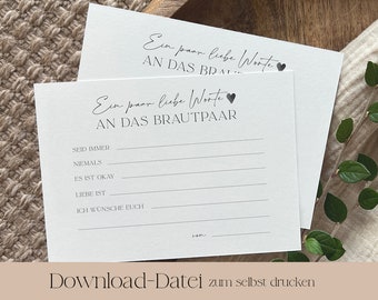 May include: Printable card with the text "Ein paar liebe Worte AN DAS BRAUTPAAR" and a small heart icon. The card has blank lines for writing messages to a newly married couple. The text "SEID IMMER", "NIEMALS", "ES IST OKAY", "LIEBE IST", and "ICH WÜNSCHE EUCH" are printed on the card. The text "Download-Datei zum selbst drucken" is printed at the bottom of the card.