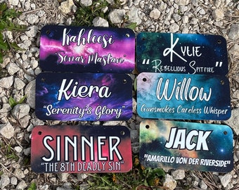 May include: Six colorful rectangular name tags with a space background. The names are Kahleesi, Kiera, Sinner, Willow, Jack, and Kylie. Each name tag has a unique quote below the name.