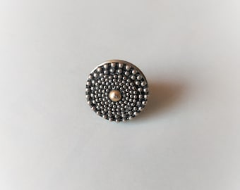 Unique white metal ring with a yellow metal ball in the center