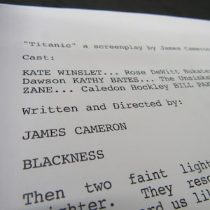 May include: A black and white photograph of a screenplay for the film "Titanic" written by James Cameron. The cast list includes Kate Winslet, Kathy Bates, and Zane. The screenplay is written in a typewriter font.