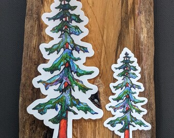 Peut inclure: Deux autocollants d'arbres colorés sur une surface en bois. Le plus grand arbre est vert, bleu et rouge. Le plus petit arbre est vert, bleu et rouge.