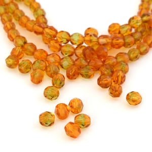 25 Czech faceted amber and green glass beads 6mm