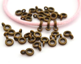 30 perles bélières bronze pour cordon 3mm