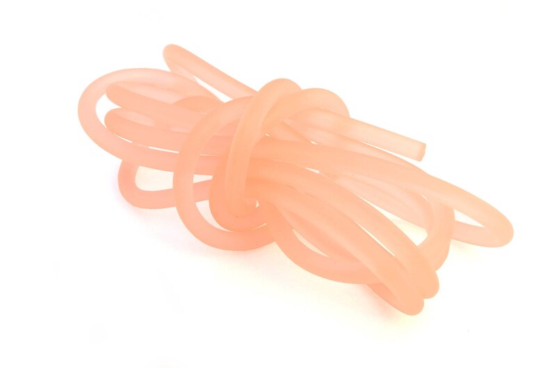 May include: A bundle of pale pink silicone tubing, twisted and knotted together.
