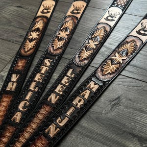 May include: Four black leather belts with intricate designs and personalized names: "VHICA", "STELLIN", "LEENJ", and "MARIJN".