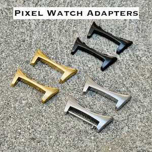 May include: Six Pixel Watch adapters arranged in three pairs of different metallic finishes. The set includes two matte black adapters, two polished gold-tone adapters, and two brushed silver-tone adapters, each featuring a curved connector design.
