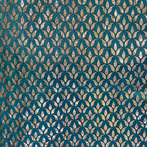 May include: Teal fabric with a repeating pattern of gold leaf stylized leaves.
