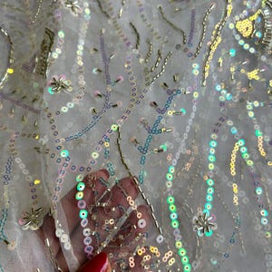 White Glittery Embroidered Net Fabric with Iridescent Sequins and Floral Accents – Luxe Bridal and Couture Sheer Fabric |Sale by Fabric Size