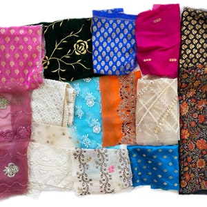 May include: Assortment of fabric scraps in various colors and patterns, including floral, geometric, and paisley designs. The fabrics are a mix of textures, including silk, cotton, and lace.