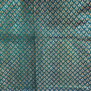 May include: Teal fabric with a gold leaf pattern. The fabric has a subtle sheen and a soft texture.
