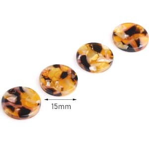 May include: Four round, 1.5 inch, brown, black, and yellow patterned resin buttons.