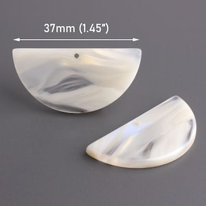 May include: Two white, semi-circular, marbled plastic pieces with a hole in the top. Each piece measures 37mm (1.45").
