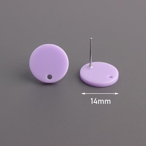 May include: A pair of lavender round stud earrings with a silver post. The earrings are 14 mm in diameter.