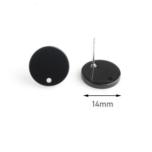 May include: A pair of black round stud earrings with a diameter of 14 mm. The earrings have a small hole in the center.