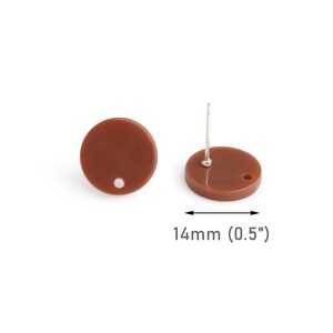 May include: A pair of brown round stud earrings with a silver post. The earrings are 0.5 inches in diameter.