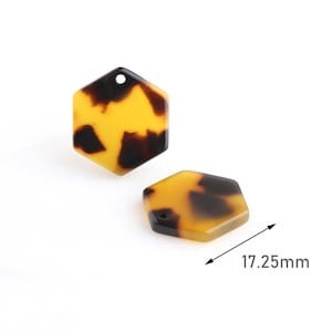 May include: Two hexagonal pendants with a tortoiseshell pattern in shades of yellow and brown. Each pendant has a small hole at the top. The size of the pendant is 0.68 inches.