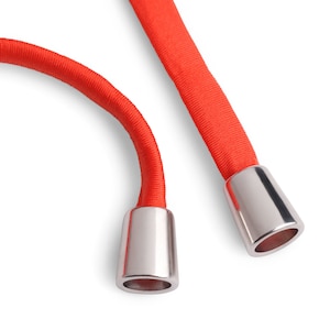 May include: Two red elastic cords with silver metal tips. The cords are looped and the tips are visible.