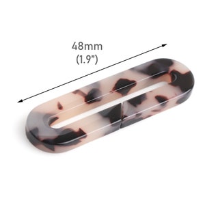 May include: A tortoiseshell-patterned plastic oval-shaped buckle, measuring 1.9 inches in length.