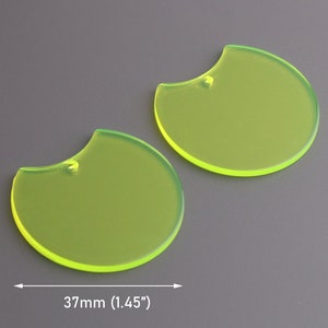 May include: Two bright yellow, semi-circular acrylic shapes with a hole in the top. The shapes are 1.45 inches in diameter.