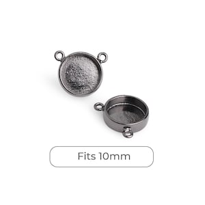 May include: Two gunmetal-colored round bezel settings with loops for jewelry making. The text "Fits 10mm" is displayed below the settings. These settings are designed to hold 10mm round inserts.