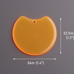 May include: A translucent orange pendant with a rounded shape and a small hole at the top. The pendant measures 1.4 inches wide and 1.3 inches tall. The edges glow with a bright orange hue, creating a striking visual effect.