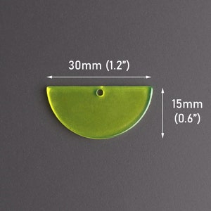 May include: A translucent, lime green, semi-circular pendant with a small hole at the top for hanging. The pendant measures 1.2 inches wide and 0.6 inches high. The dimensions are indicated with white arrows and text.