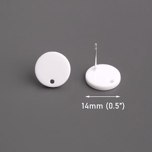 May include: White round earring with a hole in the center. The earring is 0.5 inches in diameter.