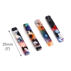 May include: Four colorful acrylic bar pendants, each measuring 1 inch in length. The pendants feature a unique abstract pattern with shades of blue, green, orange, and black.