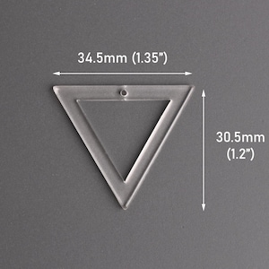 May include: Clear acrylic triangle with a hole for hanging. The triangle measures 1.35 inches wide and 1.2 inches tall. The shape is a geometric design, suitable for crafting or jewelry making.