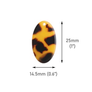May include: A brown and yellow oval-shaped resin pendant with a tortoise shell pattern. The pendant measures 1 inch in diameter and 0.6 inches in width.