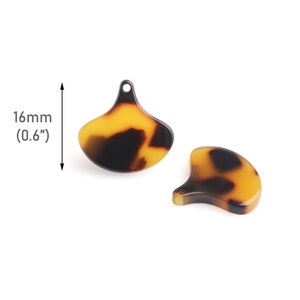 May include: Two brown and yellow tortoise shell plastic fan-shaped charms with a hole at the top. The charms are 0.6 inches in size.