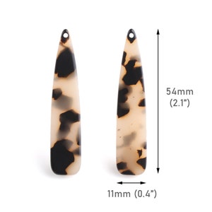 May include: A pair of brown and white tortoiseshell hair clips, each measuring 2.1 inches long and 0.4 inches wide.