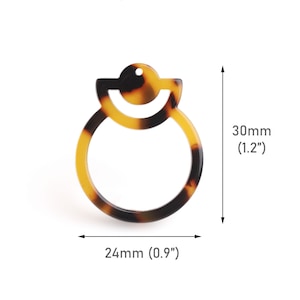May include: A tortoiseshell-colored plastic earring with a double circle design. The earring measures 1.2 inches in height and 0.9 inches in width.