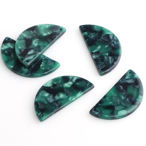 May include: Five green and black marbled half-circle resin pieces with holes for hanging.