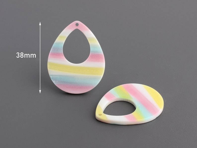 May include: Two colorful striped teardrop-shaped earrings with a hole at the top. Each earring measures 38 mm in length.