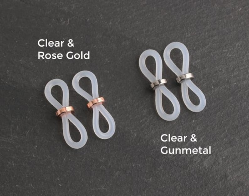May include: Two pairs of clear silicone glasses strap holders with metal accents. One pair has rose gold accents and the other has gunmetal accents.  Clear & Rose Gold and Clear & Gunmetal are written below each pair.