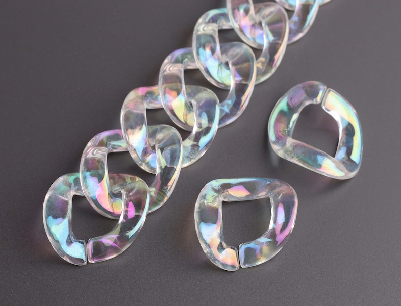 May include: A chain made of iridescent clear plastic links. The chain is made of individual links that are shaped like a rounded rectangle. The links are connected to each other by a small hole in each corner.