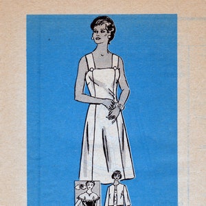 May include: A vintage sewing pattern for a sleeveless dress with a simple design. The pattern is printed on a blue background and includes instructions for making the dress. The pattern number is 4527 and the size is 12.