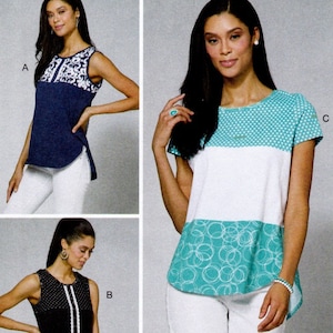 May include: Three sleeveless tops with different designs. One top is navy blue with a white floral pattern, another is black with white polka dots and a white trim, and the third is white with turquoise accents and a circle pattern. The tops are from Nancy Zieman.