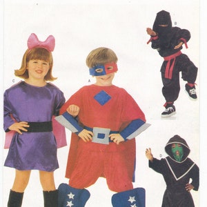 May include: A sewing pattern for four children's costumes: a purple superhero, a red superhero, a black ninja, and a black hooded figure. The pattern number is 6757 Butterick. All sizes are included.