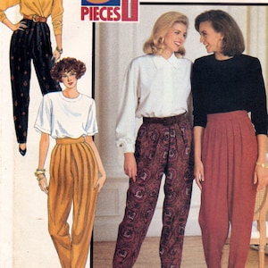 May include: A sewing pattern for three pieces of clothing, including a white blouse, a black top, and a pair of pants. The pants are shown in three different patterns: a paisley print, a solid red, and a solid yellow. The pattern is labeled "3 Pieces" and has a barcode.