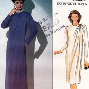 May include: Two women's dress patterns. The pattern on the left is a long, dark blue dress. The pattern on the right is a shorter, white dress with a draped neckline. The text "Patterns American Designer" is at the top of the image.
