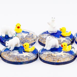 May include: A set of three ceramic mugs with a speckled, matte finish. The mugs are in shades of cream, light gray, and dark gray. Each mug has a simple, minimalist design and a rounded handle. The mugs are stacked on top of each other.