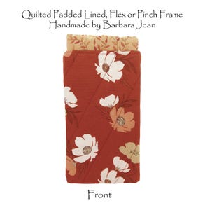 May include: A quilted red fabric eyeglass case with a floral pattern. The case is lined with a beige fabric with a floral pattern. The text "Quilted Padded Lined, Flex or Pinch Frame Handmade by Barbara Jean" is printed above the case. The word "Front" is printed below the case.