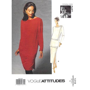 May include: A sewing pattern for a dress with two different styles. The first style is a red dress with a simple, straight silhouette. The second style is a white dress with a more fitted bodice and a skirt with a slit up the side. The pattern is from Vogue Attitudes and is size 14.