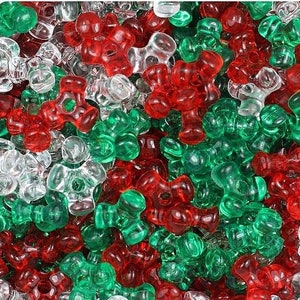 May include: A large assortment of plastic Christmas tree beads in red, green, and clear. The beads are shaped like a four-leaf clover.