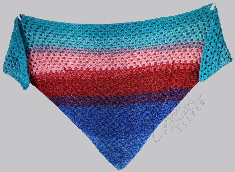 May include: A triangular crocheted shawl with stripes of teal, purple, pink, red, and blue yarn. The shawl is made with a lacy stitch pattern.