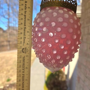 May include: Pink hobnail glass hanging lamp with a decorative brass crown and chain. The lamp is approximately 6 inches tall. The text on the ruler reads: "A rule to prevent forest fires..." and "SMOKEY'S FRIENDS DON'T PLAY".